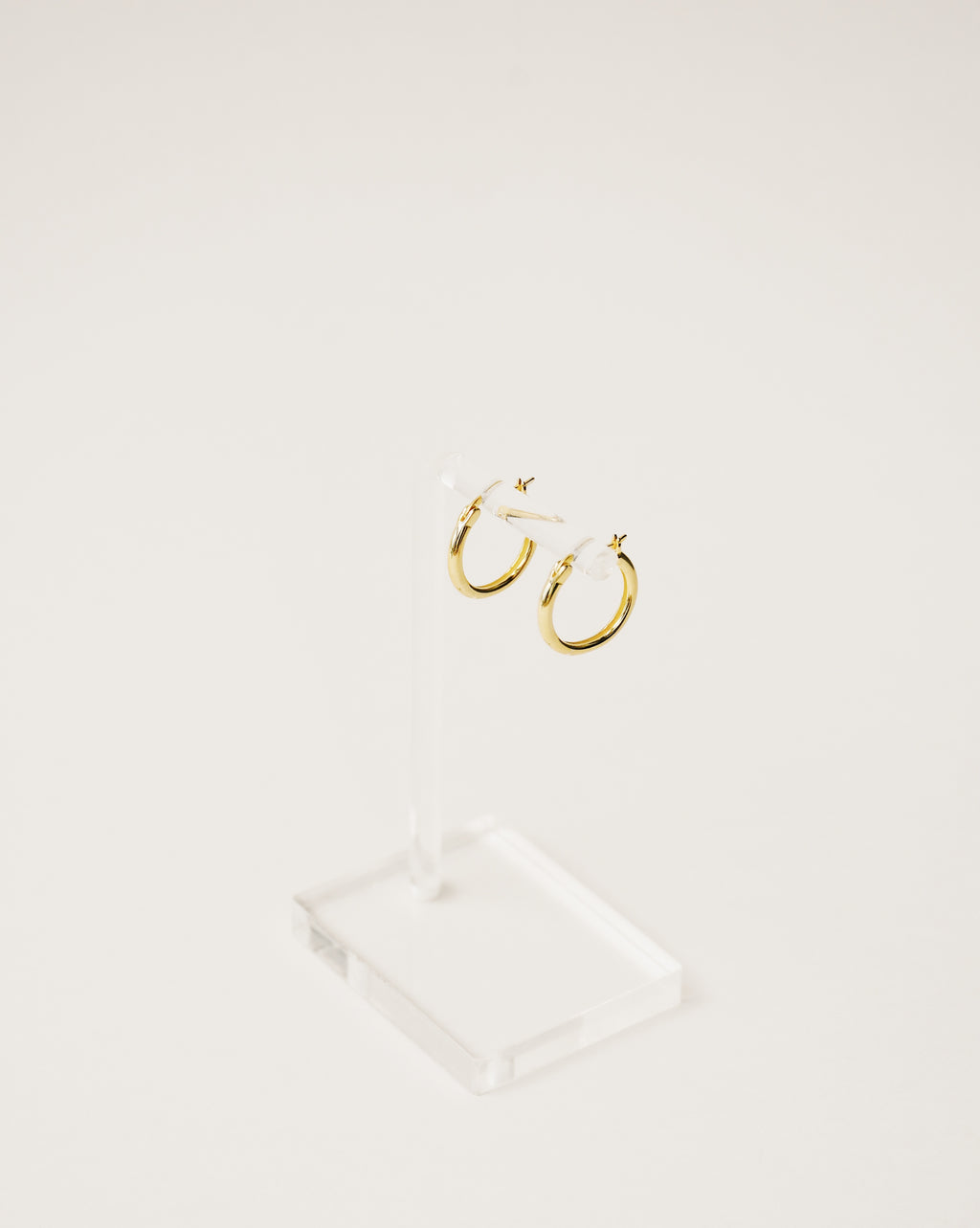 Basic shapes. minimalist and timeless mini hoop earrings handcrafted from 925 sterling silver plated in 18k gold. 2020 slow fashion trend.