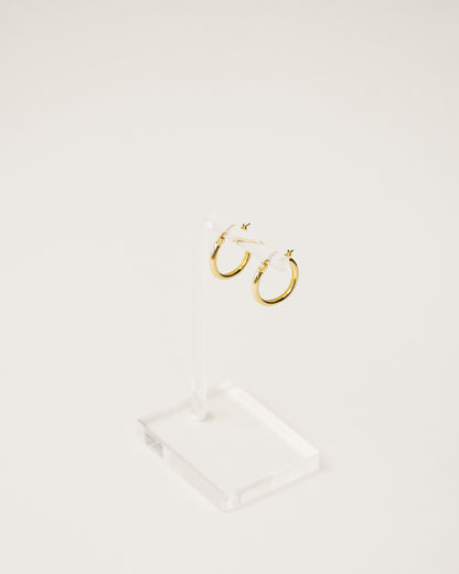 Basic shapes. minimalist and timeless mini hoop earrings handcrafted from 925 sterling silver plated in 18k gold. 2020 slow fashion trend.