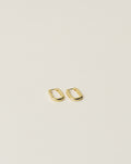 timeless and versatile oval shape huggie earrings handcrafted from 925 sterling silver plated in 18k gold. slow fashion trend 2020.