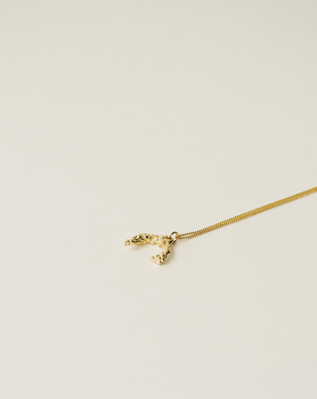 irregularly shaped pendant necklace handcrafted from 925 sterling silver plated in 18k gold. 2020 slow fashion trend.