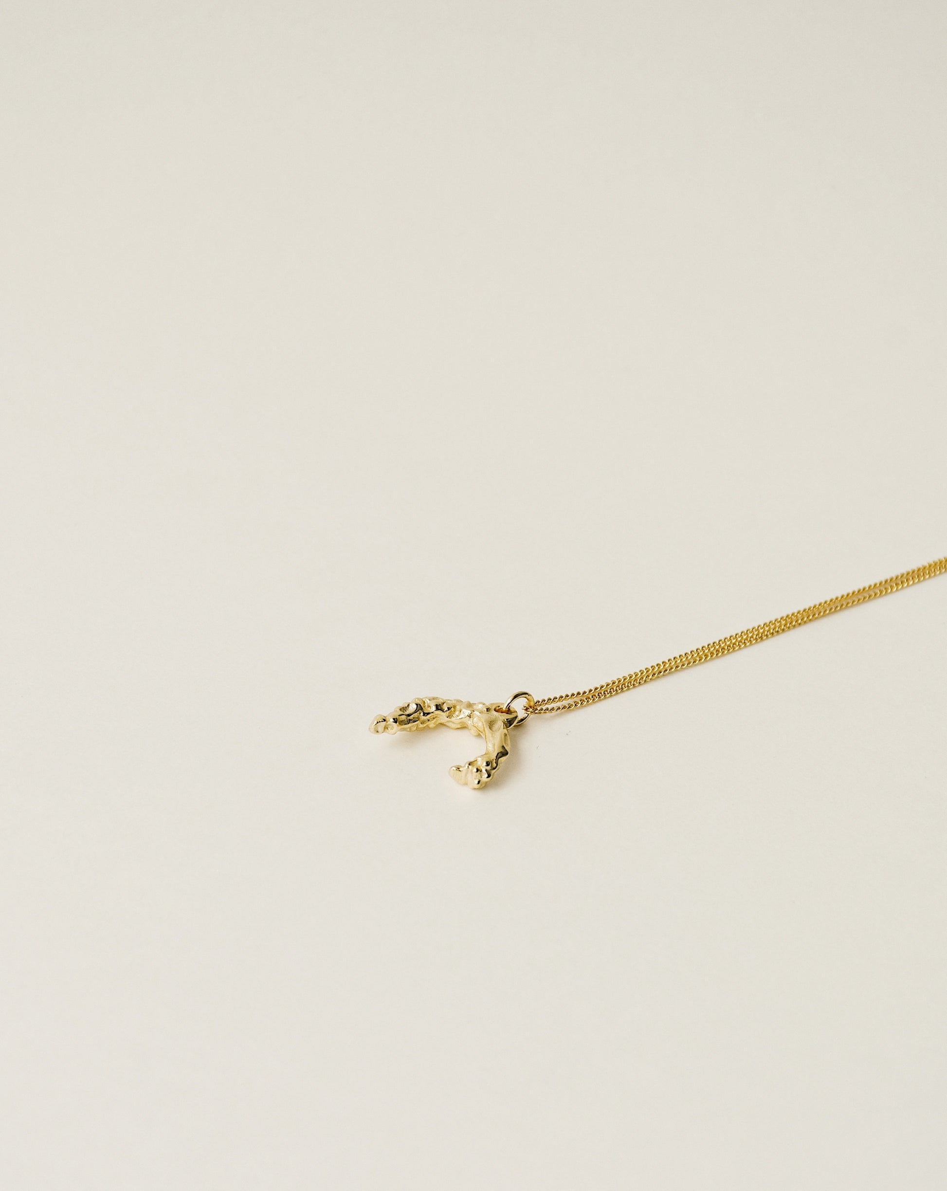 irregularly shaped pendant necklace handcrafted from 925 sterling silver plated in 18k gold. 2020 slow fashion trend.