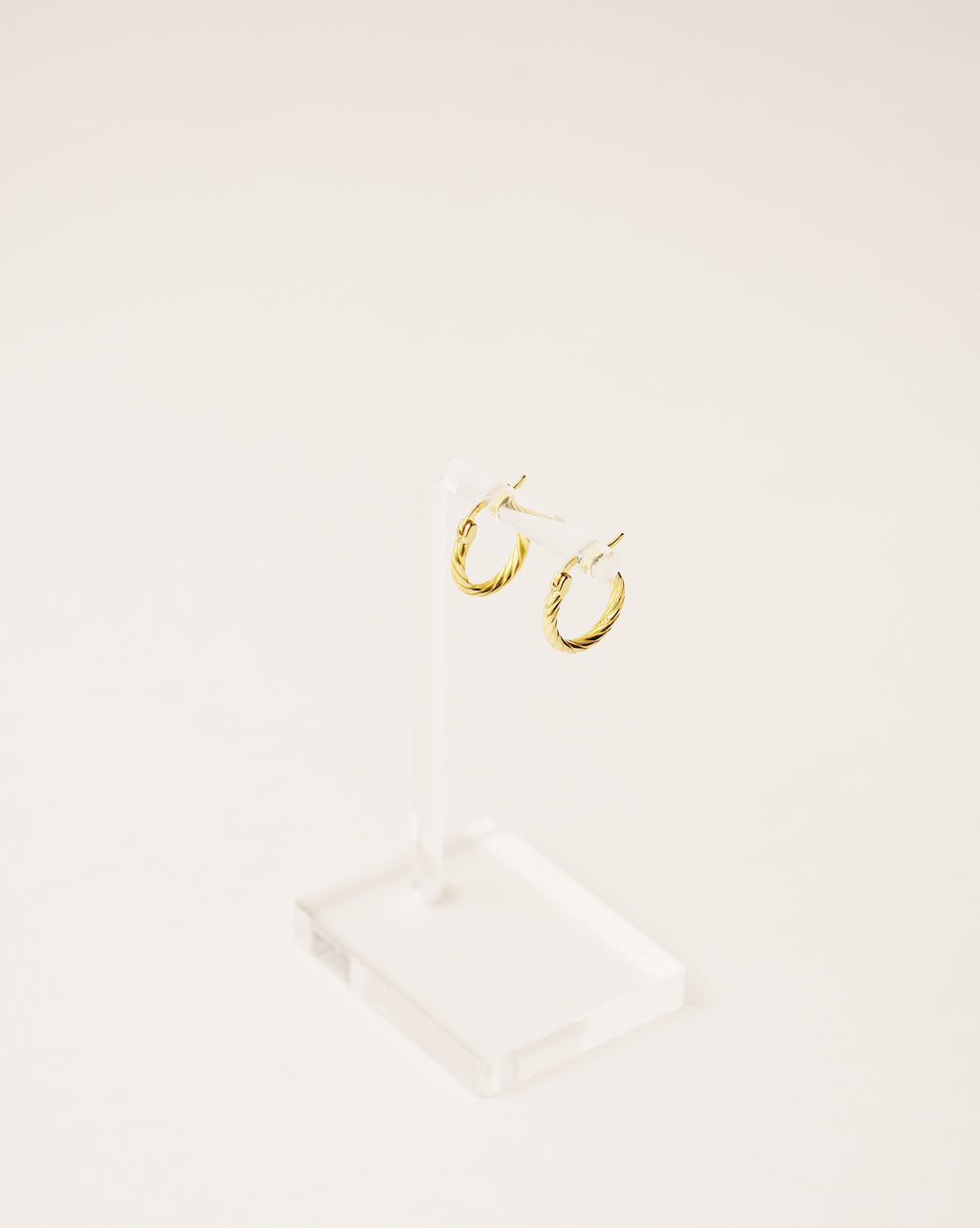 timeless and versatile twisted hoop earrings handcrafted from 925 sterling silver plated in 18k gold. 2020 slow fashion trend.