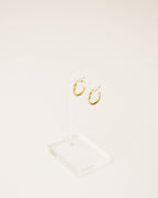 timeless and versatile twisted hoop earrings handcrafted from 925 sterling silver plated in 18k gold. 2020 slow fashion trend.