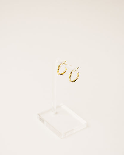 timeless and versatile twisted hoop earrings handcrafted from 925 sterling silver plated in 18k gold. 2020 slow fashion trend.