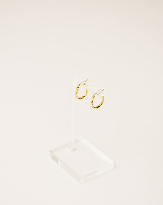 timeless and versatile twisted hoop earrings handcrafted from 925 sterling silver plated in 18k gold. 2020 slow fashion trend.