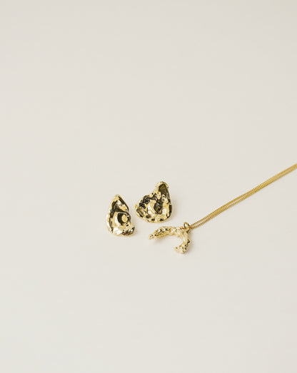 irregularly shaped stud earrings and necklace handcrafted from 925 sterling silver plated in 18k gold. 2020 slow fashion trend.