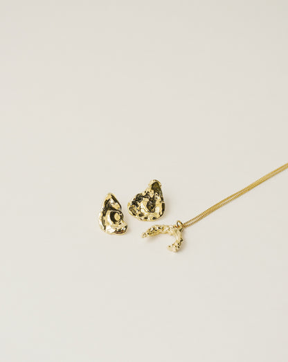 irregularly shaped stud earrings and necklace handcrafted from 925 sterling silver plated in 18k gold. 2020 slow fashion trend.