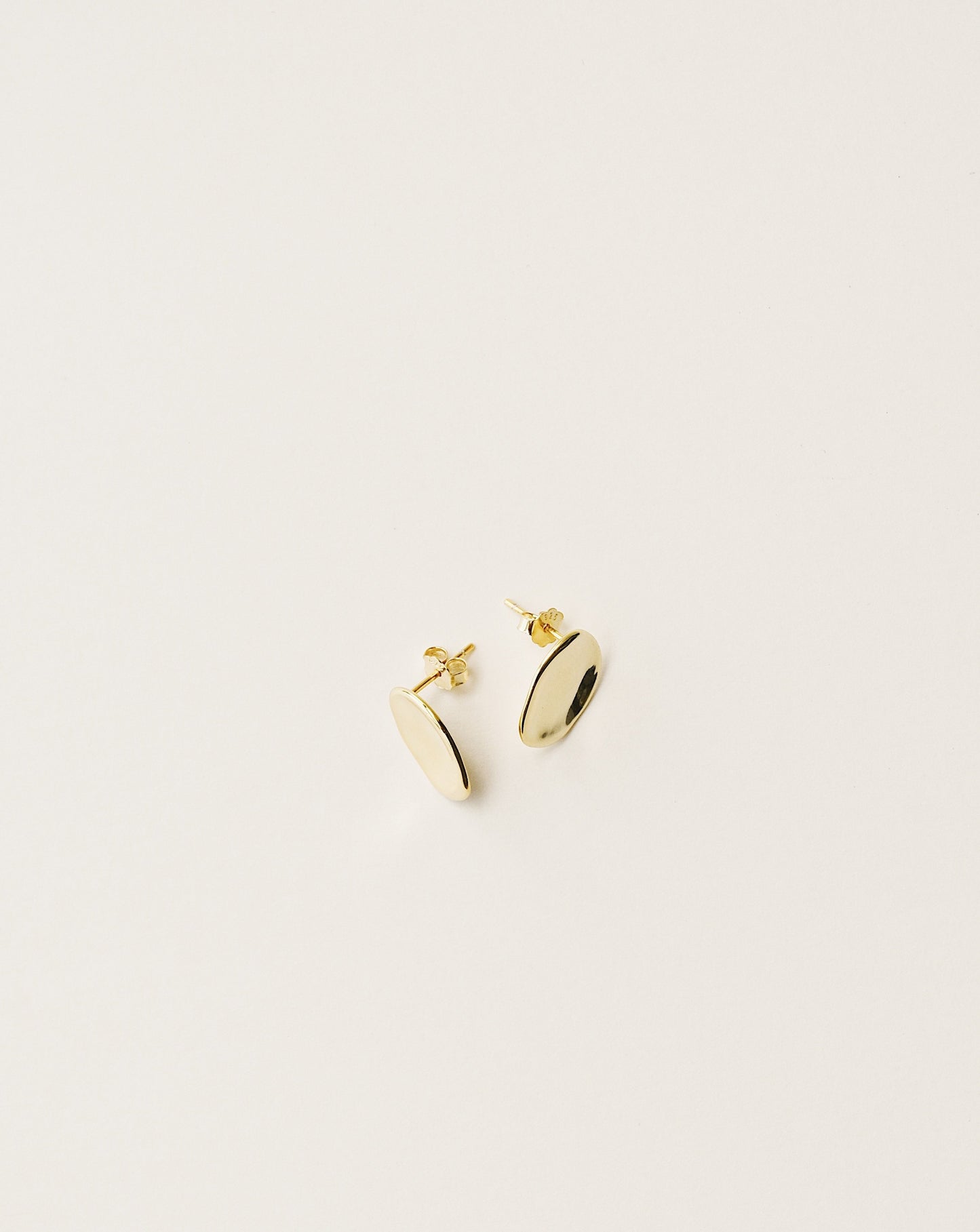 irregularly shaped stud earrings handcrafted from 925 sterling silver plated in 18k gold. 2020 slow fashion trend.