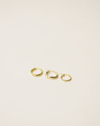 set of three different twisted hoop earrings handcrafted in 925 sterling silver plated in 18k gold. 2020 slow fashion trend.