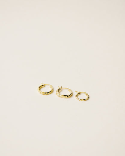 set of three different twisted hoop earrings handcrafted in 925 sterling silver plated in 18k gold. 2020 slow fashion trend.