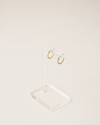 timeless and versatile twisted huggie earrings handcrafted from 925 sterling silver plated in 18k gold. 2020 slow fashion trend.