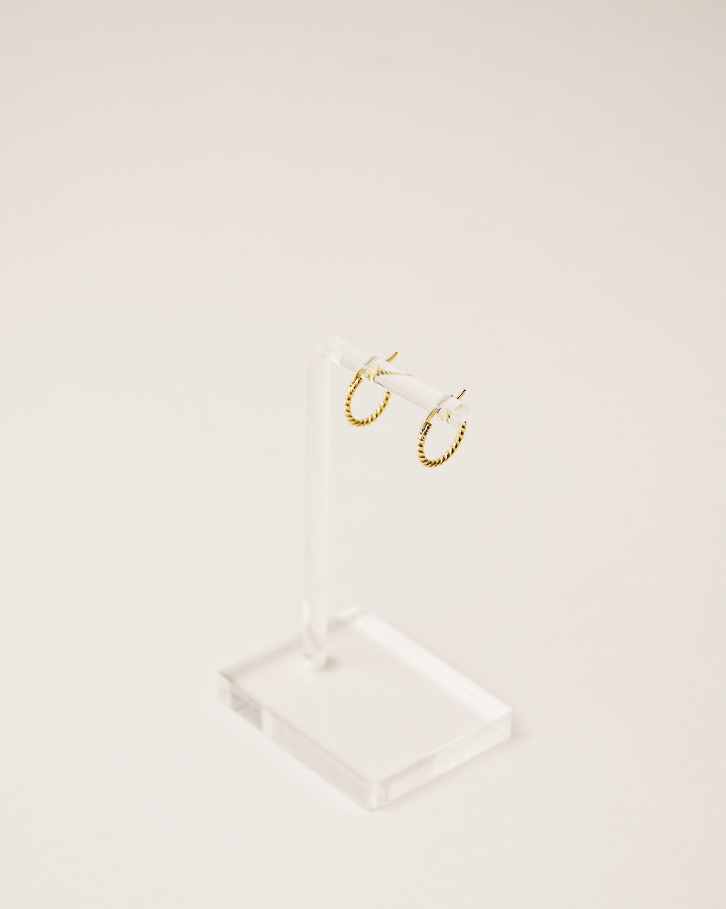 timeless and versatile twisted huggie earrings handcrafted from 925 sterling silver plated in 18k gold. 2020 slow fashion trend.