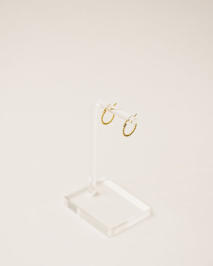 timeless and versatile twisted huggie earrings handcrafted from 925 sterling silver plated in 18k gold. 2020 slow fashion trend.