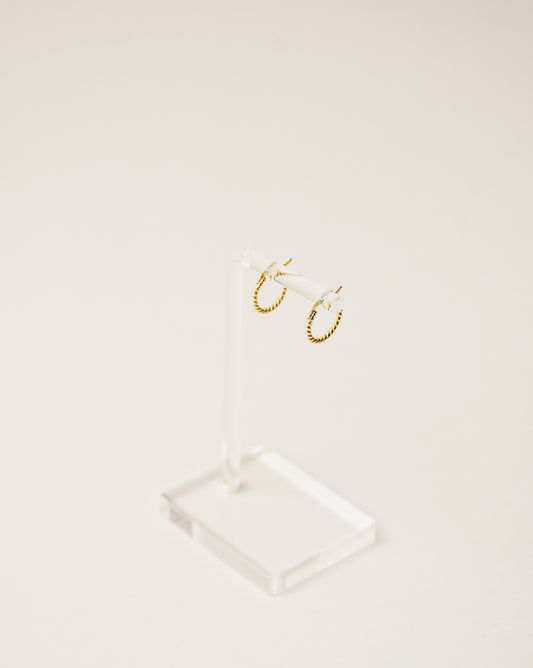 timeless and versatile twisted huggie earrings handcrafted from 925 sterling silver plated in 18k gold. 2020 slow fashion trend.