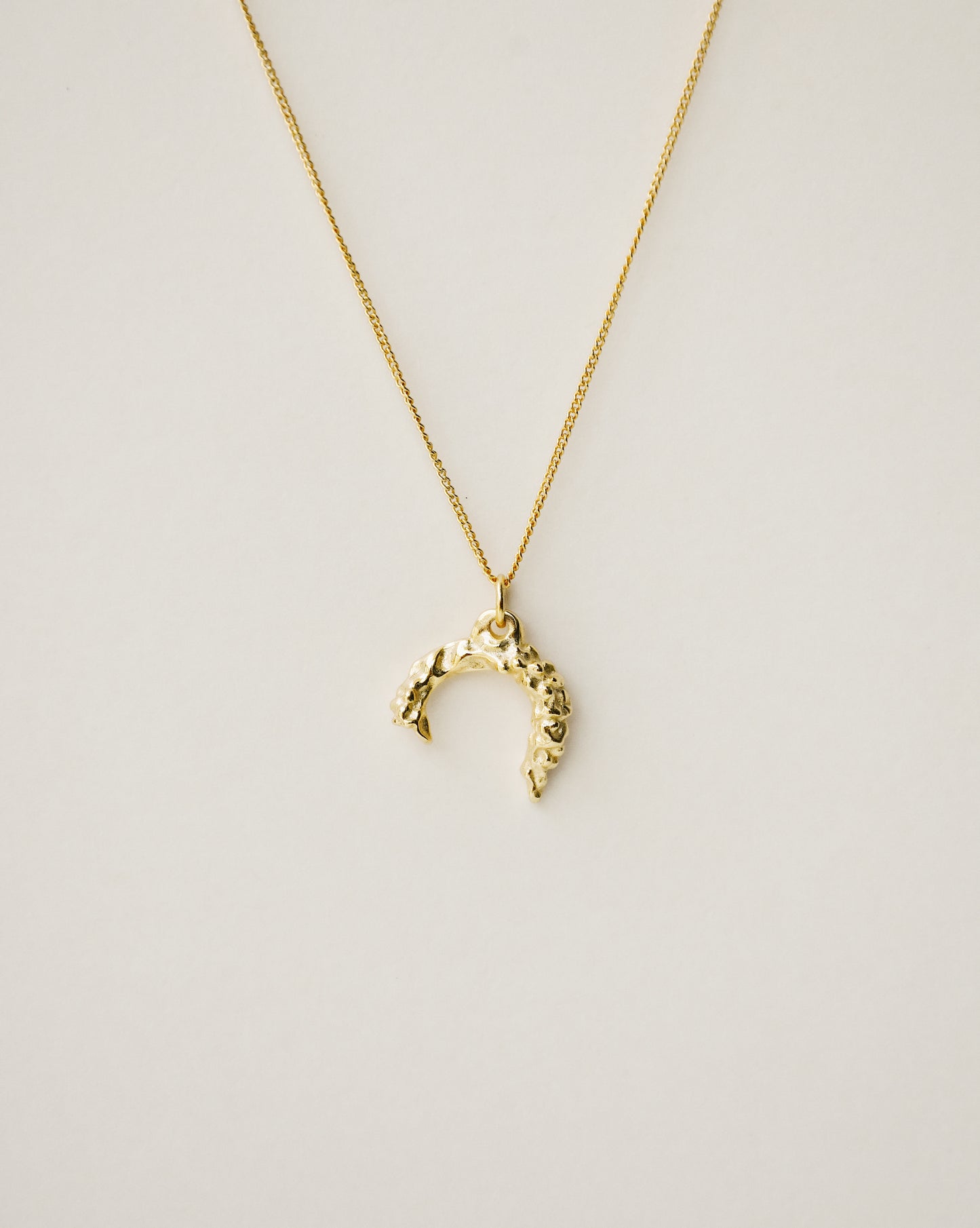 irregularly shaped pendant necklace handcrafted from 925 sterling silver plated in 18k gold. 2020 slow fashion trend.
