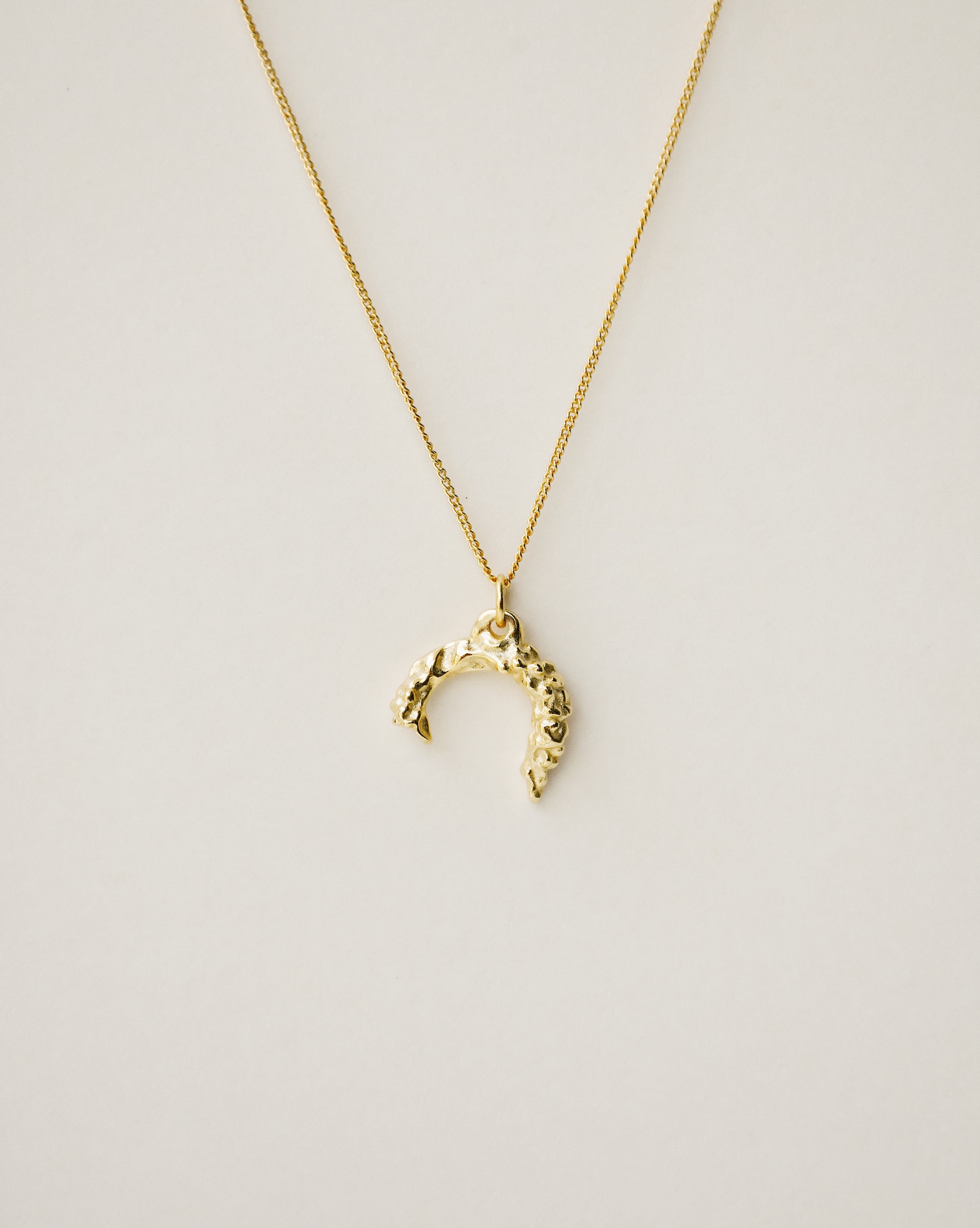 irregularly shaped pendant necklace handcrafted from 925 sterling silver plated in 18k gold. 2020 slow fashion trend.