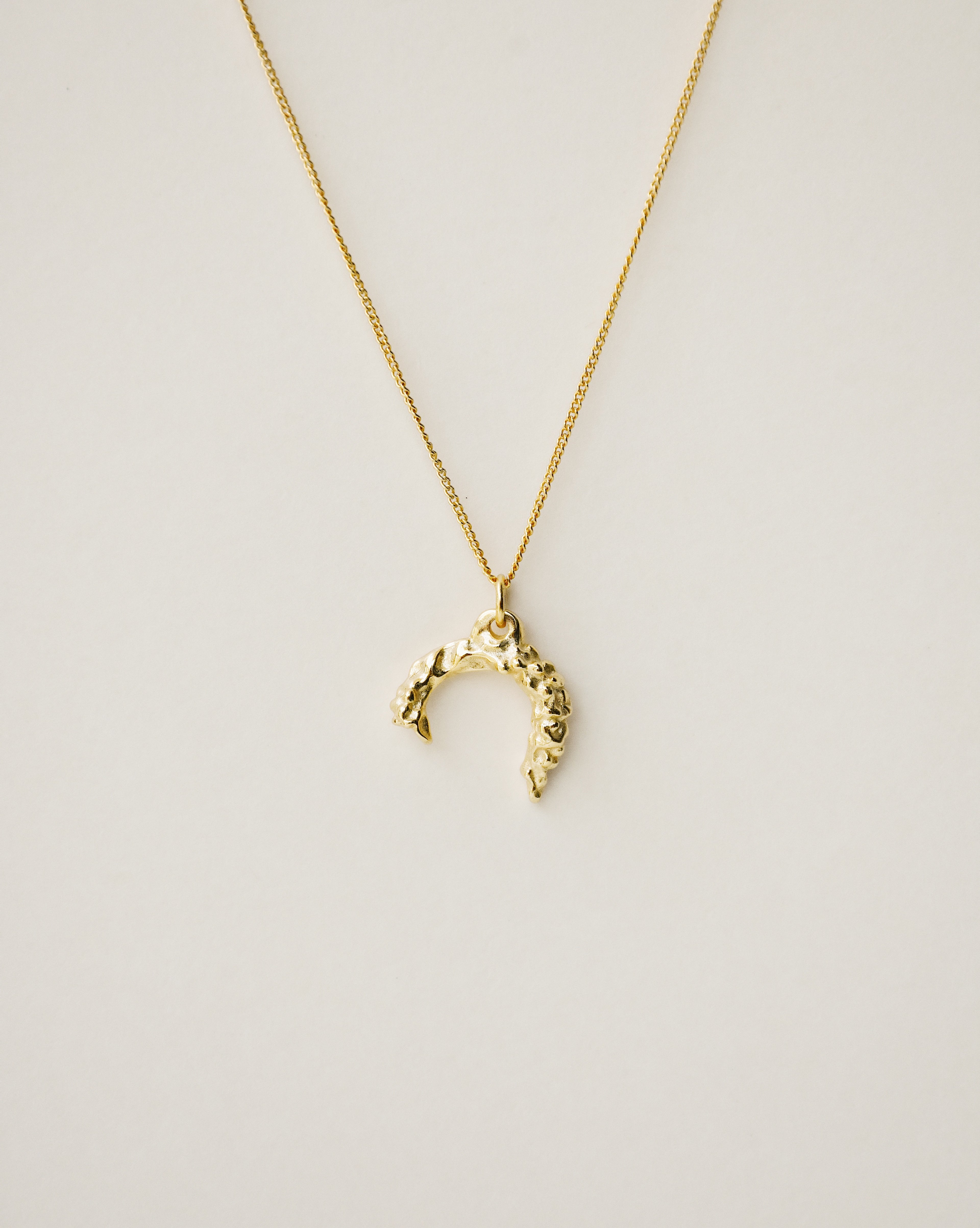 irregularly shaped pendant necklace handcrafted from 925 sterling silver plated in 18k gold. 2020 slow fashion trend.